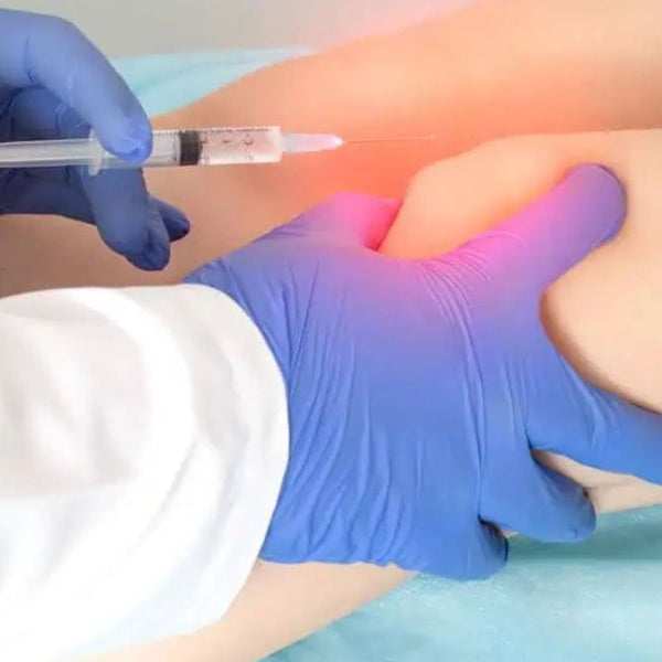 Person receiving an injection on their leg with a gloved hand holding a syringe.